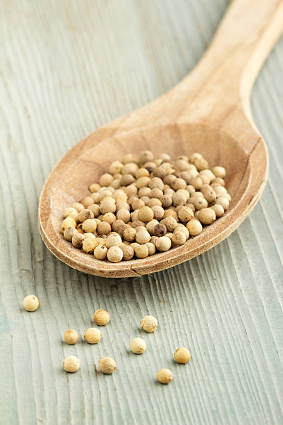istock white peppercorns in a wooden spoon 464981467