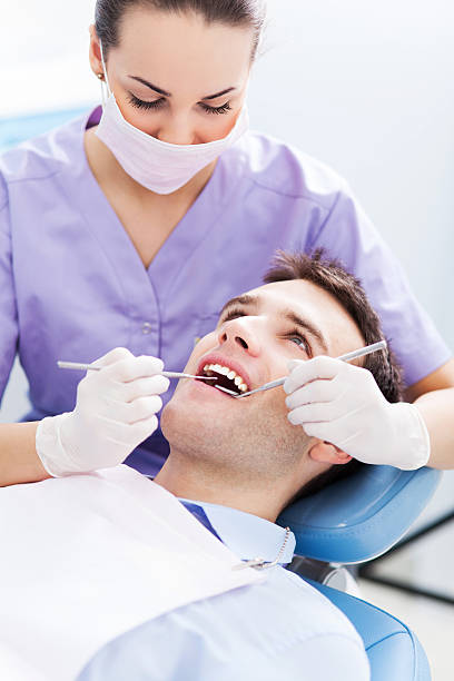 istock Young man at dentist office 464987287
