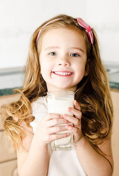 istock Beautiful little girl drinking milk 464987953