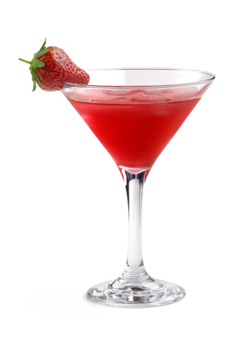 red cocktail garnished with strawberry in a martini glass on white background