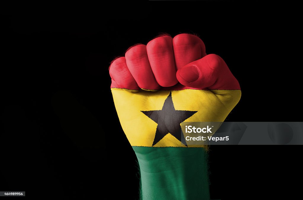 Fist painted in colors of ghana flag Low key picture of a fist painted in colors of ghana flag 2015 Stock Photo