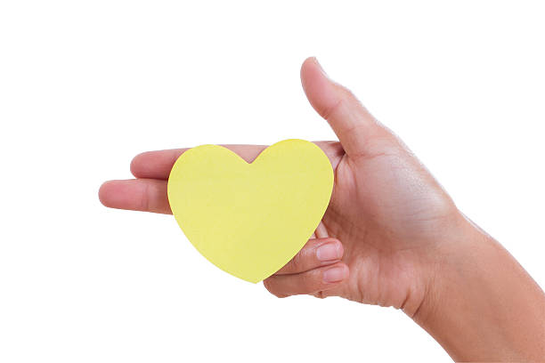 istock hand holding paper heart, 464990283