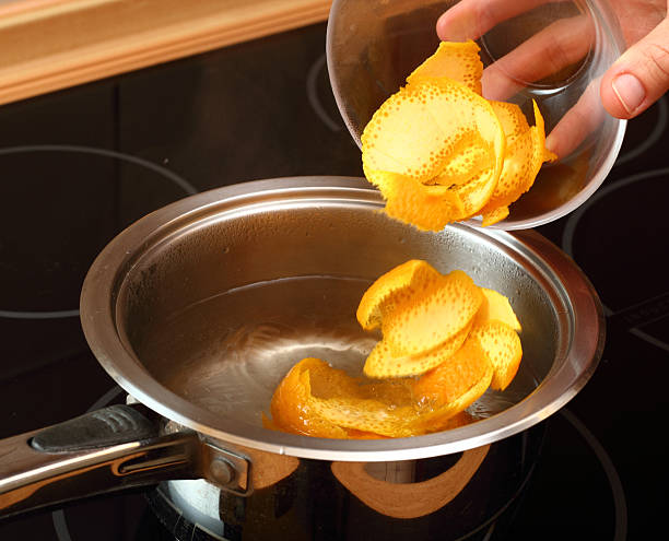 Add orange peel into saucepan with boiling syrup