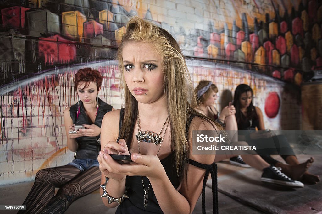 Concerned Woman on Phone Concerned young blond female using cell phone Adolescence Stock Photo