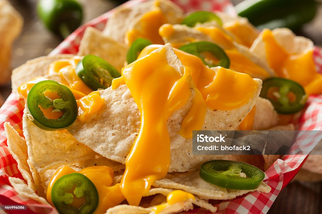 Homemade Nachos with Cheddar Cheese Homemade Nachos with Cheddar Cheese and Jalapenos Nacho Chip Stock Photo