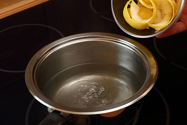 istock Add lemon peel into saucepan with boiling syrup 464996283