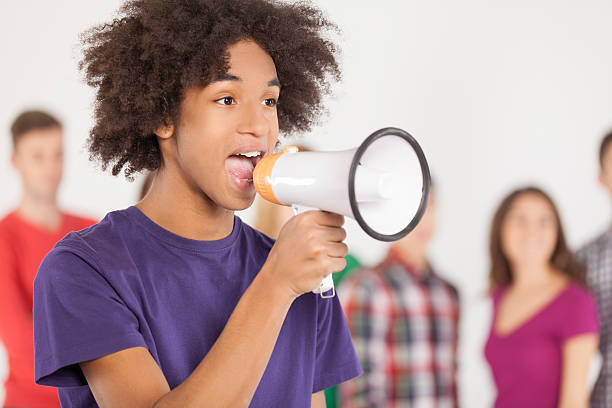 istock A young man yelling into a bullhorn 464998055