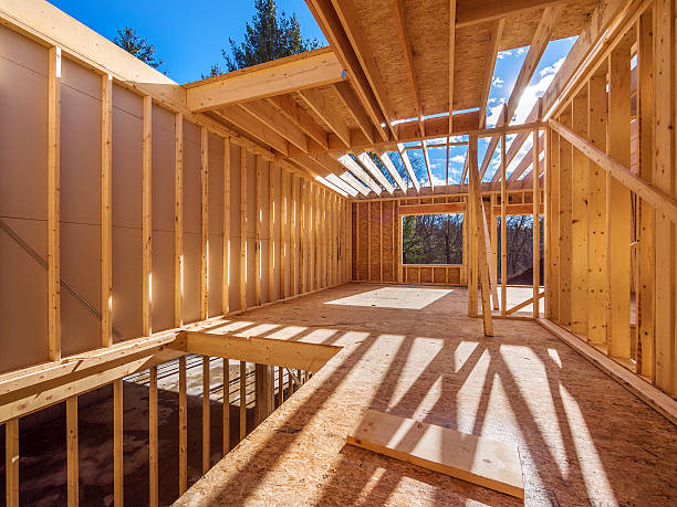 New framing construction of a  house New framing house construction with no roof and two by fours exposed post structure photos stock pictures, royalty-free photos & images