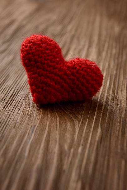 istock red heart on wooden background 464999389