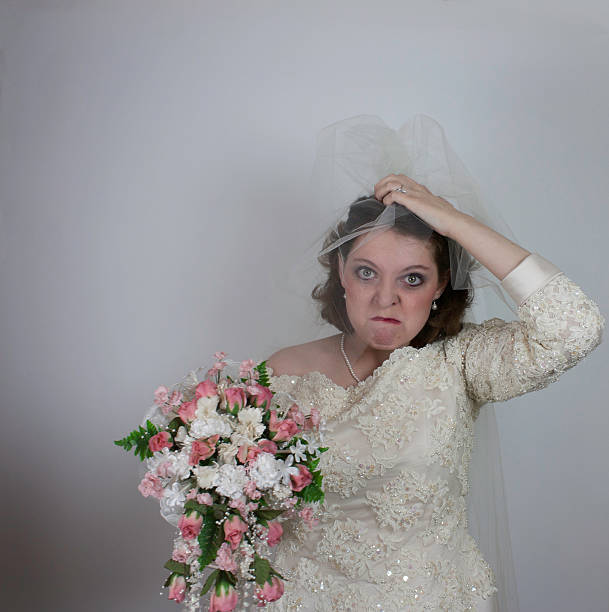 istock Young bride makes a stressful face and holds bouquet 465005995