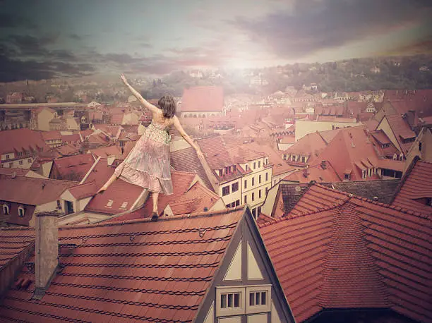 Young girl on top of the roof. Photomanipulation. Concept digital graphic