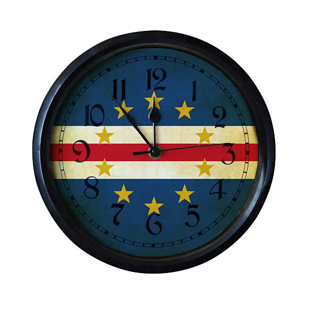 An old Cape-Verde flag wall clock with grungy background - isolated over white.