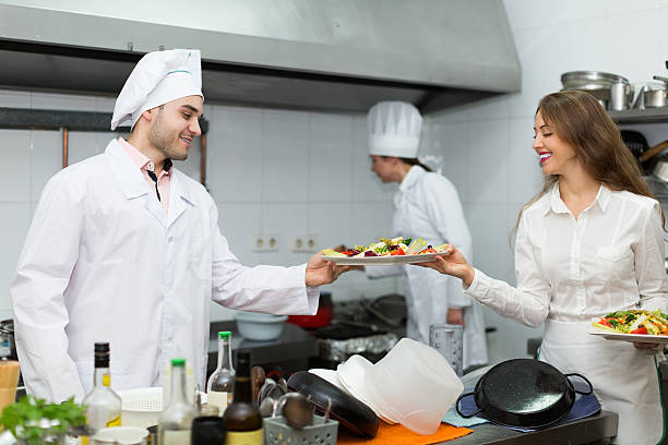 istock Waitress with food at kitchen 465010662