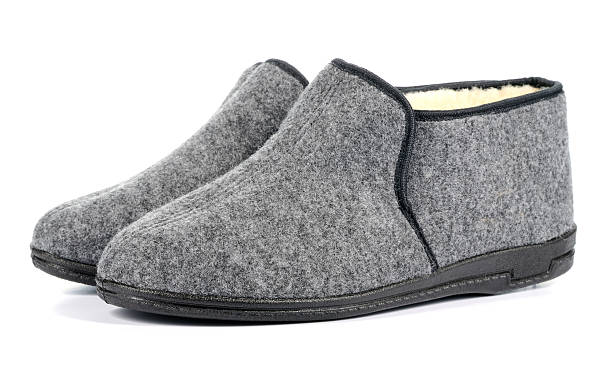 istock Pair of men's grey slippers on white background. 465011329