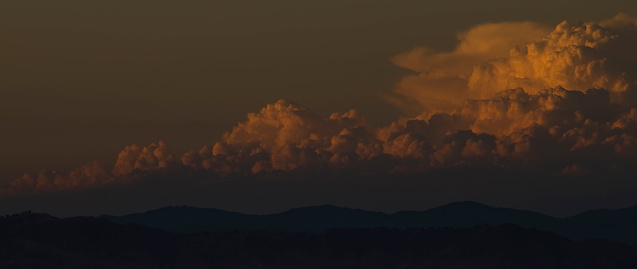 Clouds build over the horizon near sunset.