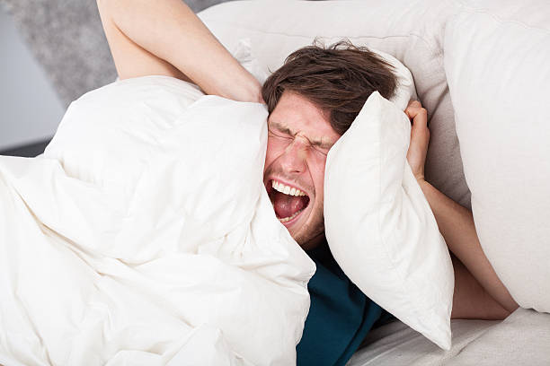 istock Angry man awoken by a noise 465015507