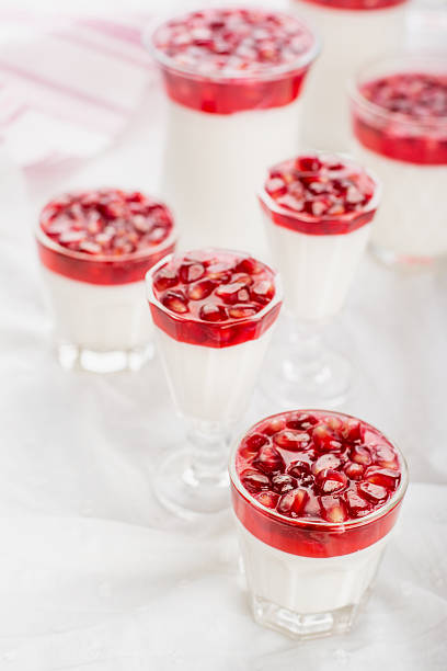 Healthy gluten free panna cotta dessert with  pomegranate seeds in jars perfect for breakfast or christmas holidays