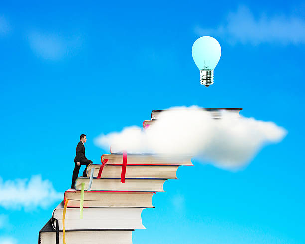 istock Businessman climbing on stack of books to reach bulb 465026963