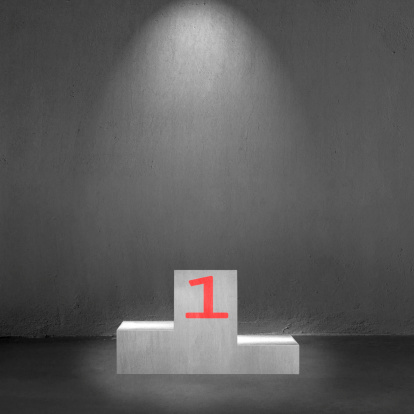 Concrete podium with number 1 on it and spot light in concrete background