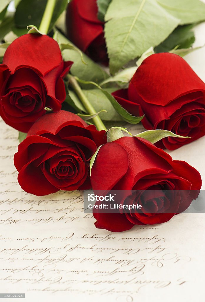 red rose flowers and old love letters red rose flowers and old love letters. romantic vintage style background. selective focus Antique Stock Photo