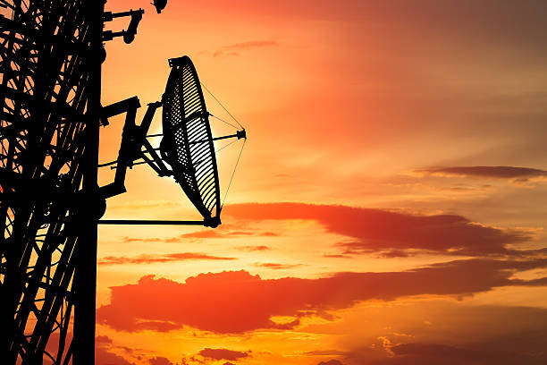 istock silhouette satellite communication tower poles on sunset 465028552