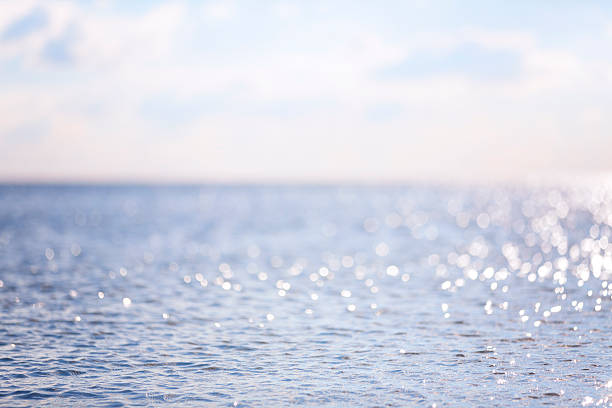 istock Sunny day by the water with sparkle lights 465030384