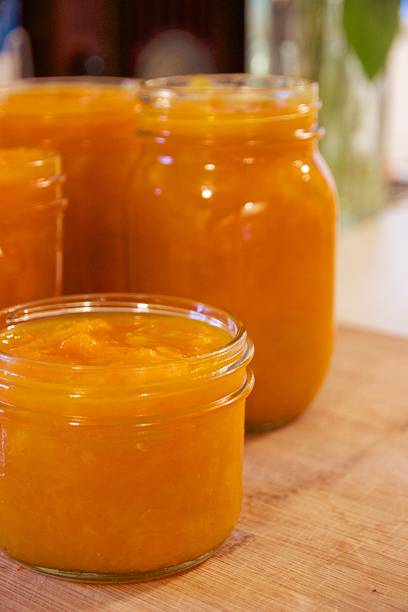 istock Jars of apricot compote or preserves on cutting board 465030648
