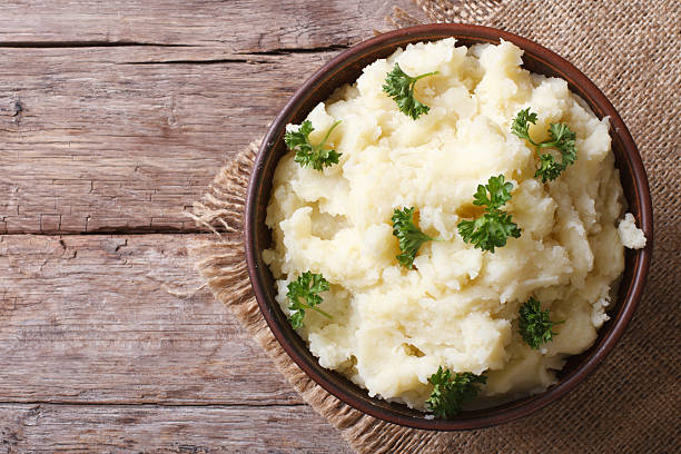 istock Hot mashed potatoes with parsley in bowl close-up. top view 465030720
