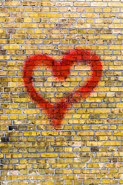 istock heart graffiti on a yellow brick wall background 465032669