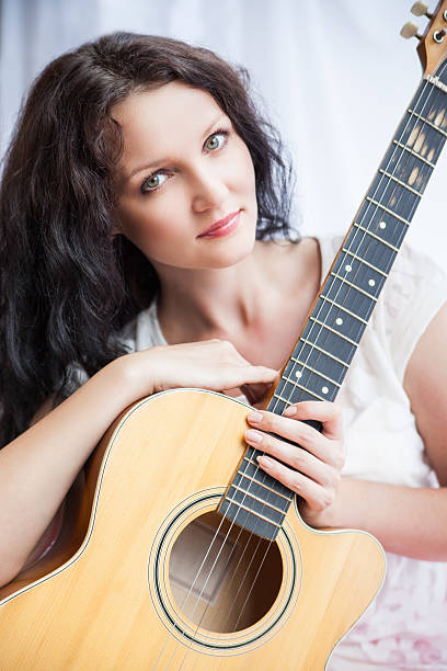 istock hippie girl with the guitar on white 465033264