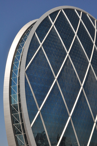 Abu Dhabi, UAE - February 15, 2014: Aldar Headquarters Building in Abu Dhabi, UAE. It is the first circular building of its kind in the Middle East.