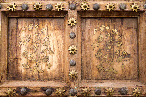 A detail from an ornate 19th-century wooden Indian carved door.