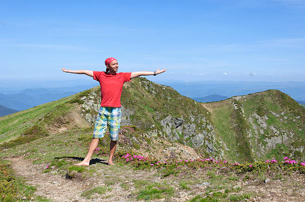 istock Trekker walking flowers field in mountain 465037334
