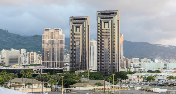 Skyline of Honolulu with residential towers against the misty hills.