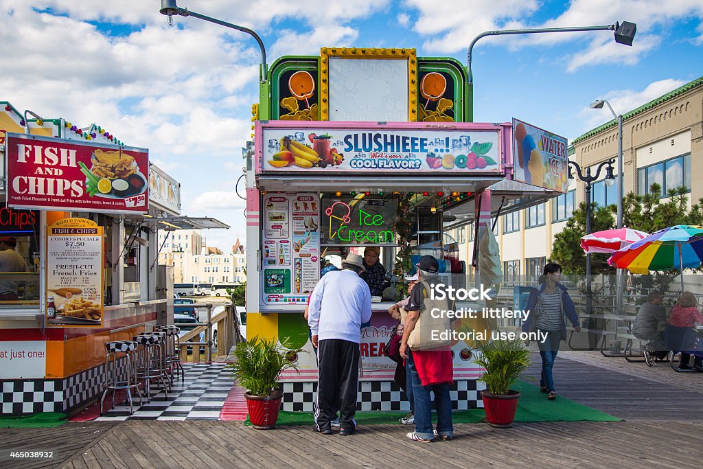 Atlantic City Boardwalk Atlantic City, New Jersey, USA - September 22, 2013:   View of snack concession stand on the Atlantic City boardwalk in New Jersey with people visible.  Atlantic City is a historic seaside resort city known for it's nostalgic boardwalk and casinos. 2015 Stock Photo