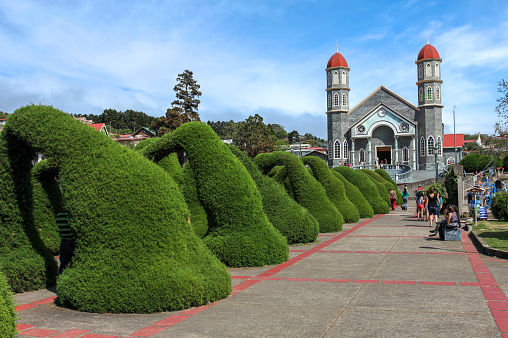 Zarcero, Costa Rica - January 18, 2015: Francisco Alvardo Park with its famous topiary features and the Church of San Rafael in Zarcero, Costa Rica