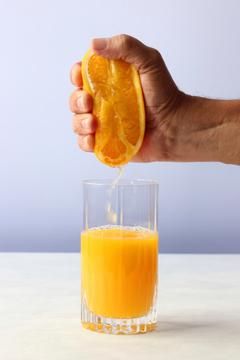Fresh hand squeezed orange juice with plenty of natural light.