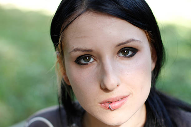 Portrait of young girl with blank expression, looking at camera.