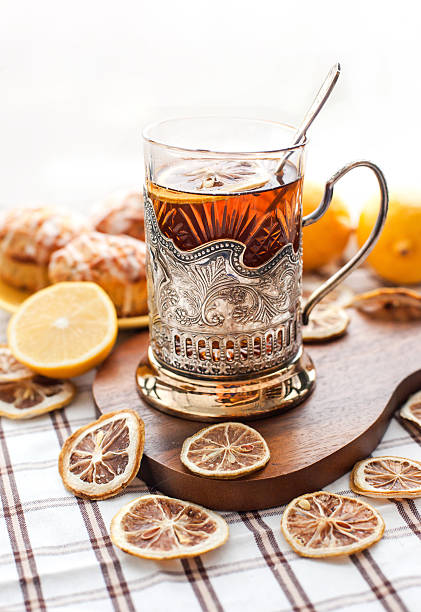 istock Black tea with lemon in the silver glass-holder 465040385
