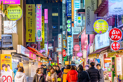 Seoul, South Korea - February 14, 2013: Crowds enjoy the Myeong-Dong district at night. The district is known as one of the main shopping and tourism areas.