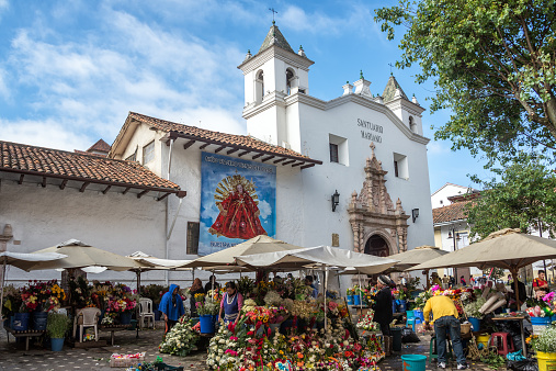Cuenca, Ecuador - December 14, 2014: Flower sellers in front of a church on December 14, 2014 in Cuenca, Ecuador