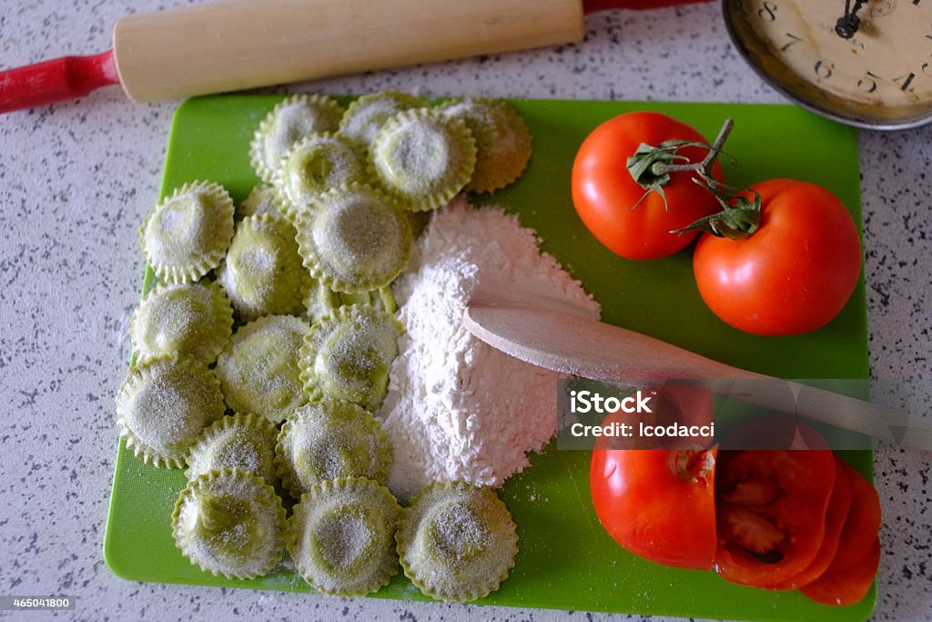 Italian cousine for Expo 2015 Green ravioli, white flour and red tomatoes make a red white and red flag. Mid-morning natural sunlight. 2015 Stock Photo