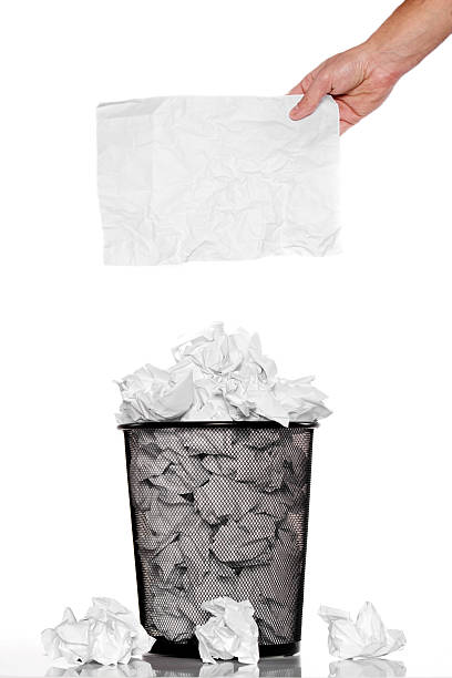 istock Hand holding a crumpled note on the trash can 465042631
