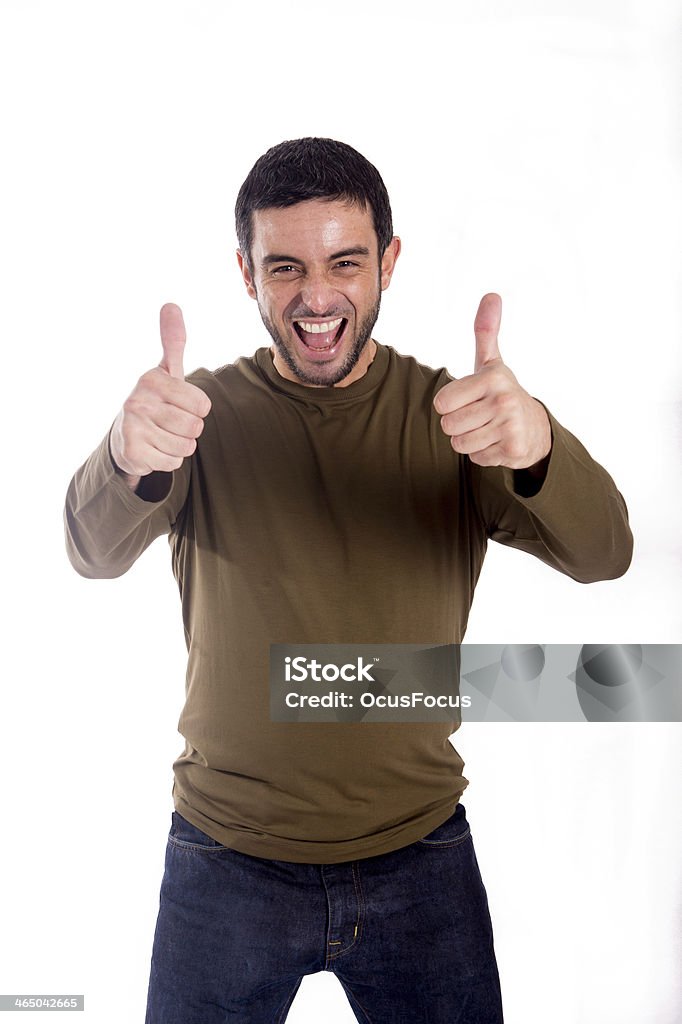 attractive happy man giving thumbs up isolated on white background man giving the double thumbs-up hand gesture wearing a brown shirt on a white background Achievement Stock Photo