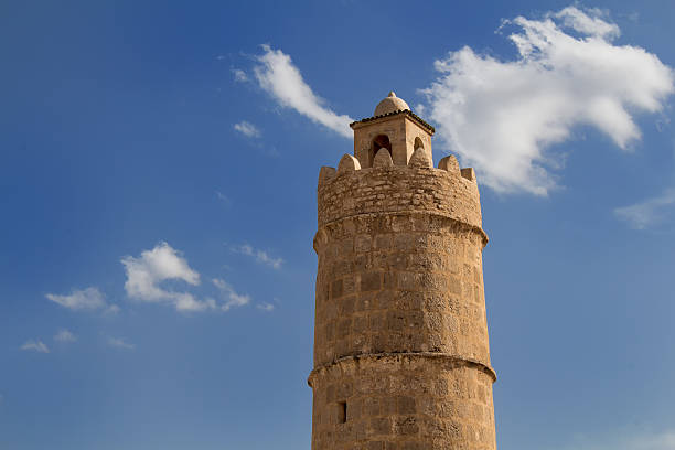 Close up minaret of mosque with detail pattern, beige and brown color