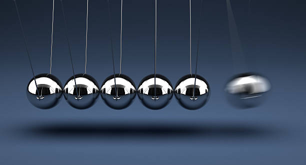 Newtons cradle being demonstrated Newton's Cradle newton balance stock pictures, royalty-free photos & images