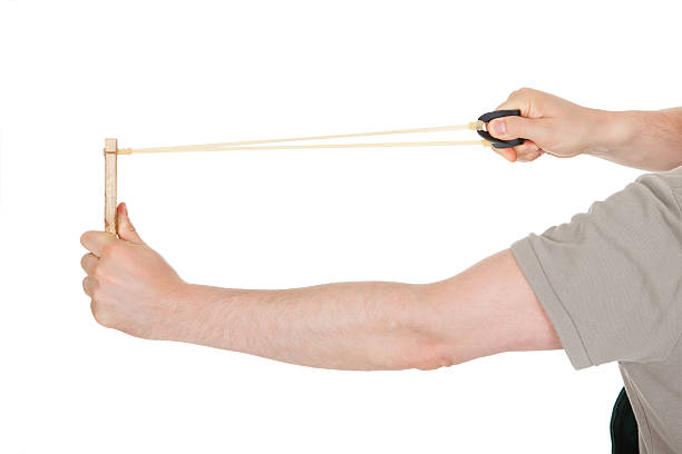 istock Close-up of hand pulling sling shot 465044191