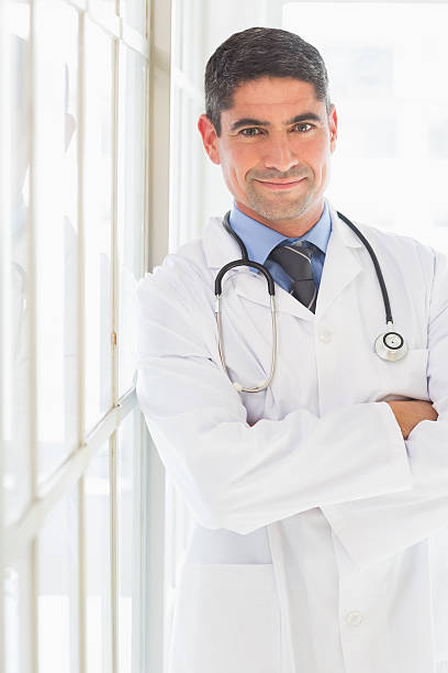 istock Doctor standing arms crossed 465046154