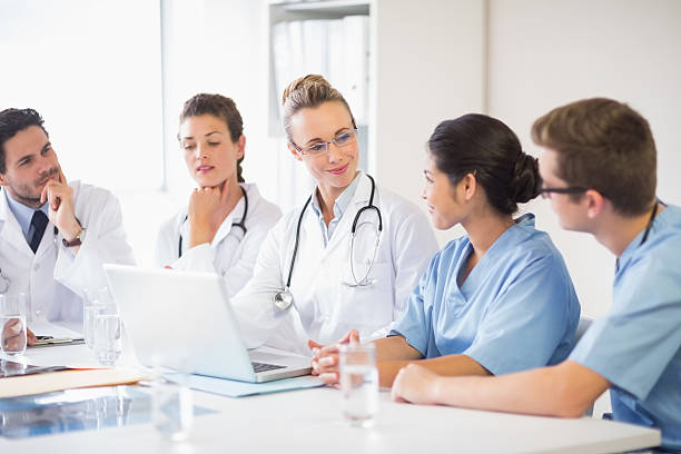 istock Team of doctors and nurses discussing 465046264