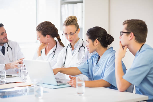 istock Doctor and nurse discussing over laptop 465046266